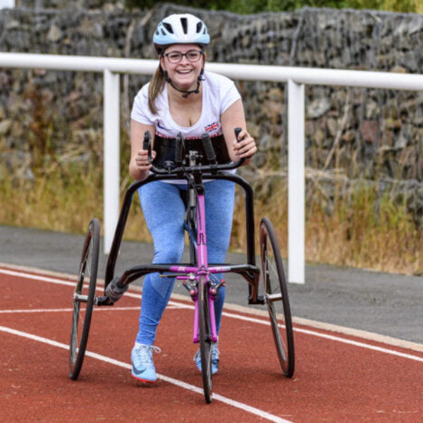 A yong woman running using adaptive running equipment 